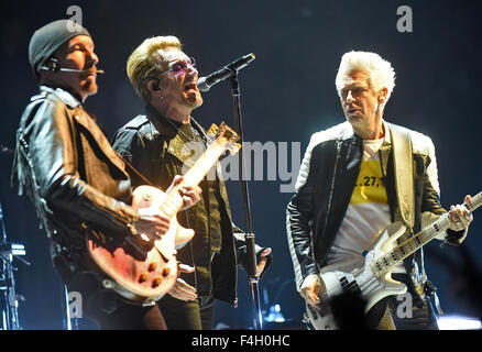 Guitarist David Howell Evans (l-r), aka The Edge, singer Paul David Hewson, aka Bono and bass guitarist player Adam Clayton performs on stage during a concert of Irish band U2 in Cologne, Germany, 17 October 2015. Photo: Henning Kaiser/dpa Stock Photo