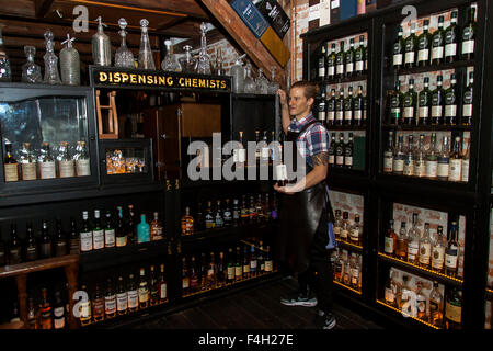 Copenhagen, Denmark, October 17th,2015. Liedkoeb is a combined 3-storey whisky and cocktail bar and restaurant located in a backyard at Vesterbrogade in Copenhagen and opened November 2012. At the photo a bartender in the whisky stillroom, which meets the guests when they enter Liedkoeb’s whisky bar on the third floor in the historical building from 1715, which served as a chemist laboratory. Stock Photo