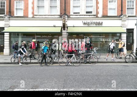 London, England, 18 October 2015. Waitrose staff cycling group assemble in Marylebone High Street prior to a London-wide tour to all Waitrose Supermarkets, London, England, UK Stock Photo