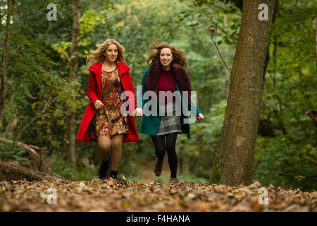 Aberystwyth Wales UK., Sunday 18 October 2015  Two young women (Iulia Nicola and Rhian Daniell) enjoying a Sunday afternoon stroll in the autumnal woodlands at Penglais Park,  Aberystwyth, Wales   Photo Credit:  Keith Morris / Alamy Live News Stock Photo