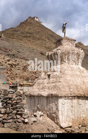 India, Jammu & Kashmir, Ladakh, Miru, remote high altitude village, old chortens below hilltop temple Stock Photo