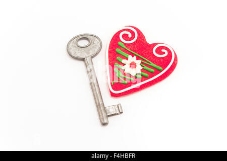 Key and heart isolated on white. Stock Photo