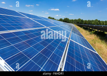 Close up of blue solar panels on ground in long straight line Stock Photo