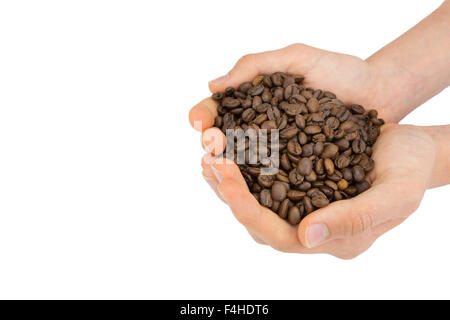 Two hands holding many coffee beans isolated on white background Stock Photo