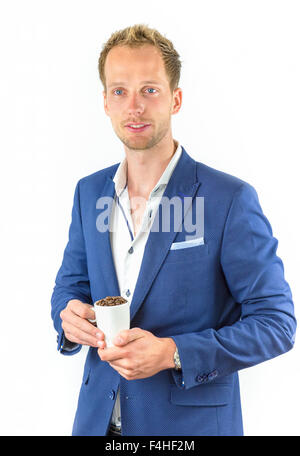 Young salesman promoting coffee beans in cup isolated on white background Stock Photo