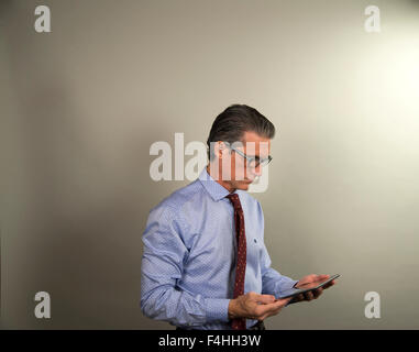 Latin executive using an electronic tablet Stock Photo