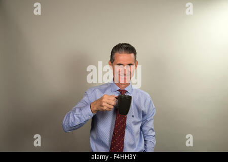 Latin Executive taking a cup of coffee Stock Photo