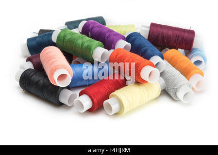 multicolored threads for sewing on spools isolated on white background Stock Photo