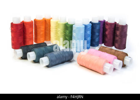 multicolored threads for sewing on spools isolated on white background Stock Photo