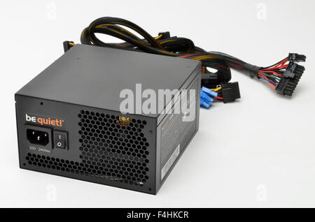 Be Quiet 550 watt computer PSU power supply unit and connecting power cables. Stock Photo