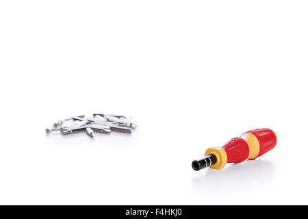 Toolbox with screwdriver and replaceable bits closeup on white background Stock Photo