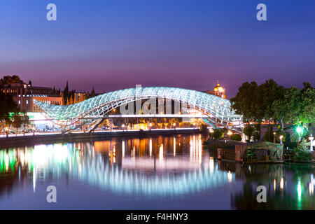 Dusk view of the Bridge of Peace, a pedestrian bridge spanning the Mtkvari River in Tbilisi, the capital of Georgia. Stock Photo