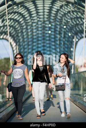 Three young women on the Bridge of Peace in Tbilisi, the capital of Georgia. Stock Photo