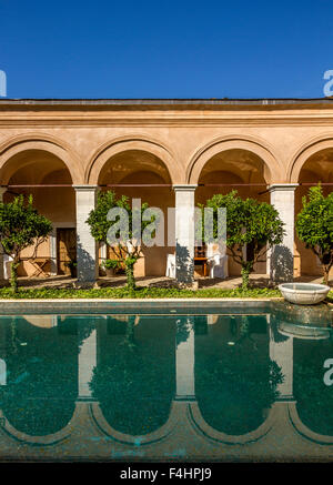 Arcades reflected in the water of a swimming pool. Stock Photo