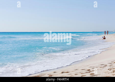 Man reading on Cancun's Hotel Zone Beach.Cancun,Quintana Roo, Mexico Stock Photo