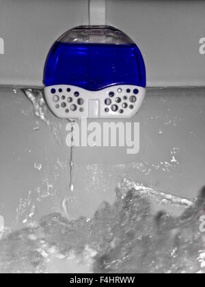 Water discharge in the toilet bowl with cleaning product Stock Photo