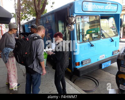 San Francisco, California, USA. 15th Oct, 2015. Homeless people sign up for the waiting list for a shower bus that reads 'One Shower at a Time' in San Francisco, California, USA, 15 October 2015. Two decommissioned city busses were refitted by the Lava Mae Project to include two spacious shower cabinets as well as toilets and sinks respectively. The busses operated by a bus driver and run by volunteers will stop in various districts of the city five days per week. Photo: Barbara Munker/dpa/Alamy Live News Stock Photo