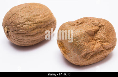 Spoiled damage kiwi on white background, unhealthy eating Stock Photo