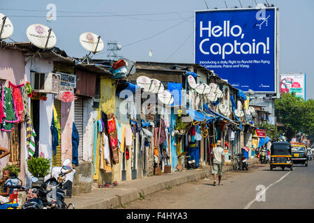 The facades of typical homes of poor working class Indians with tv dishes on the roofs, similar to the buildings in slum areas Stock Photo