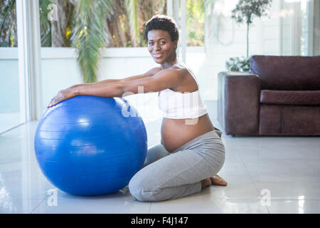 Portrait of cheerful pregnant woman exercising with ball Stock Photo