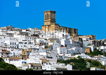 Basilica de Santa Maria de la Asuncion rises above the White Town, of Arcos de la Frontera, Andalusia, Spain Stock Photo