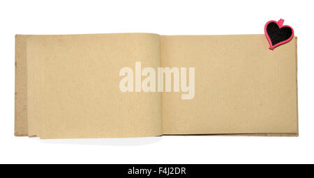 Opened notebook made of handmade paper with heart-shaped wooden clipper Stock Photo