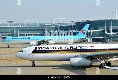 Airbus A 330-300 of Singapore airlines and Boeing 777 of Korean airlines Incheon international airport South Korea Stock Photo
