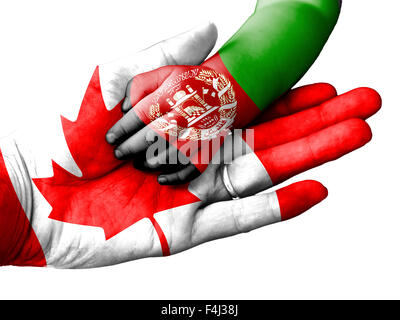 Flag of Canada overlaid the hand of an adult man holding a baby hand with the flag of Afghanistan overprinted Stock Photo