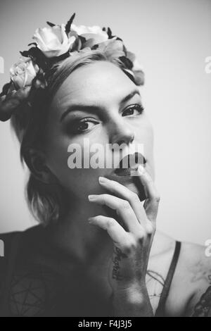 Young tattooed woman wearing a flower crown Stock Photo