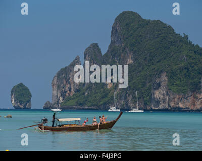 Tourists on long-tail boat in the Phi Phi islands, Andaman sea, Thailand, Southeast Asia, Asia Stock Photo