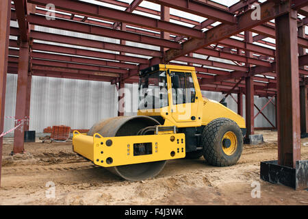 Large road roller being used to construct Stock Photo