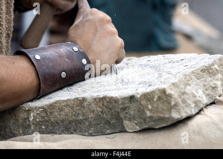 Stone carving - reconstruction of medieval stone work . Stock Photo