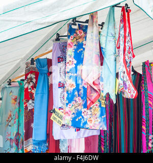 Shawl for women on sale at outdoor market. Italy Stock Photo