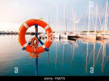 life belt at a marina with sailing boats Stock Photo