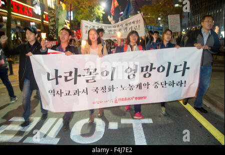 Koreans demonstrate against the introduction of a state-approved history textbook on Oct 17, 2015, in Seoul, Korea. Protesters march during a candlelight vigil against South Korean government's plan for state-approved history textbook in Seoul, South Korea. Hundreds of people demonstrated as they insisted that the state-approved history textbook would glorify pro-Japanese collaborators during the Japanese colonial rule (1910-45) in Korea and dictatorial regimes in contemporary history of South Korea. A placard (front) reads,'The state of our country is a mess. Stop the plan for state-approved Stock Photo