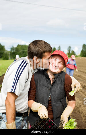 Two people working in a field, Finland. Stock Photo