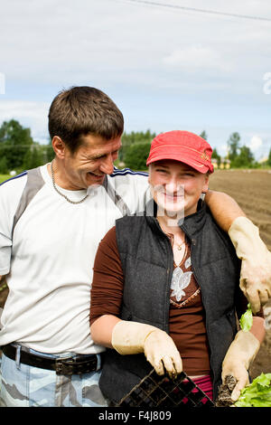 Two people working in a field, Finland. Stock Photo