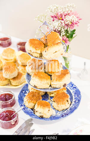 Arrangement of freshly-baked scones on decorative chinaware. Stock Photo