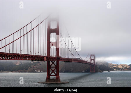 Golden Gate Bridge partially covered in fog, San Francisco, California, USA