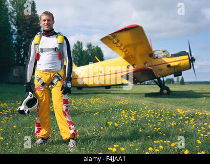 Parachute jumper in front of a plane Stock Photo