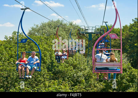 Tourists travelling down to Alum Bay beach on the Isle Of Wight using the chairlift. Stock Photo