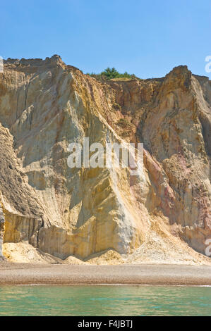 A view of the multi-coloured sand cliffs at Alum Bay beach on the Isle Of Wight on a sunny day. Stock Photo