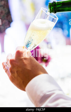 Sparkling wine being poured into a champagne flute. Stock Photo