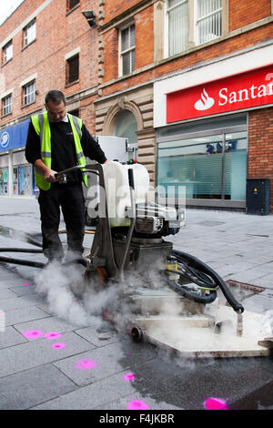 Southport, Merseyside, UK 19th October, 2015.  Launch of Keep Britain Tidy Campaign. Trial of street chewing gum removal machine in Southport operated by Primoserve Environmental Ltd in advance of the launch of the latest Keep Britain Tidy campaign on the 20th October.  The particular machine, one of only three in the country, uses high temperature steam to remove and loosen the gum which is then transferred to an adjacent trailer.  The discarded street pavement gum, to be targeted, is highlighted with a magenta fluorescent spray. Stock Photo