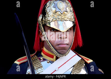 London, England, UK. Black member of the Horseguards on duty outside Horse Guards Parade - Blues & Royals Stock Photo