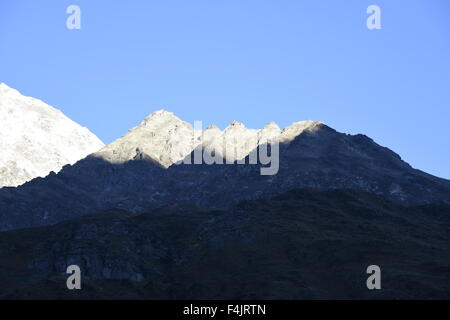 Badrinath mountain peak covered by heavy snow, Badrinath with first sunlight in  early morning and clear blue sky August 2015 Stock Photo