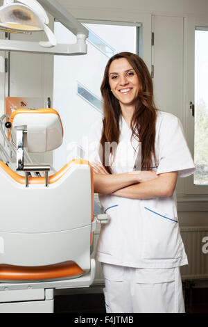 Portrait of smiling dentist in dentists office Stock Photo