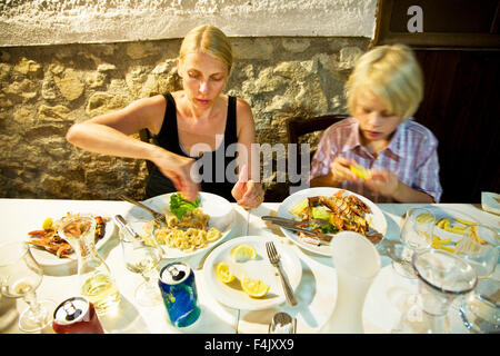Mother and son eating in restaurant Stock Photo