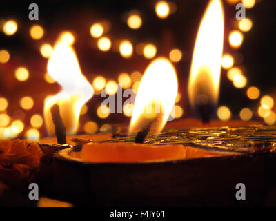 Traditional Lamps lit on the occassion of Diwali festival on the backdrop of blur lights Stock Photo