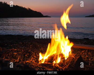 A driftwood fire on a Turkish beach, during a sea kayaking expedition Stock Photo